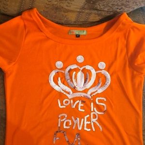 Orange sequin accent  "Love Is Power" shirt.